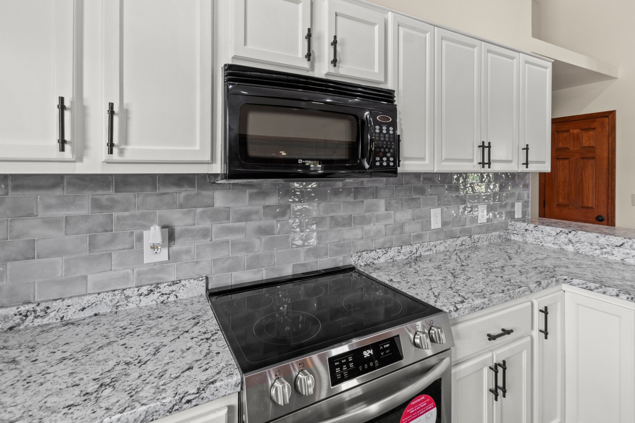 1351 Sumac Road Pulaski, TN 38478 - Photo 17 of 53 a kitchen with granite countertop stainless steel appliances a stove microwave and sink