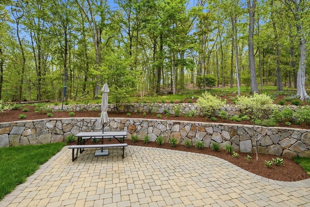 6 Flintlock Road Lexington, MA 02420 - Photo 36 of 39 a white bench sitting in the middle of a yard