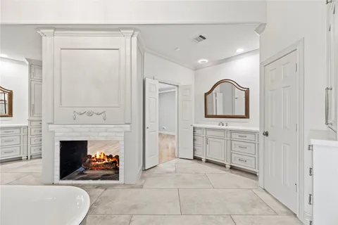 a view of a livingroom with a fireplace cabinet and window