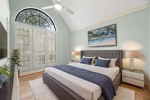 a bedroom with a large bed and a large window