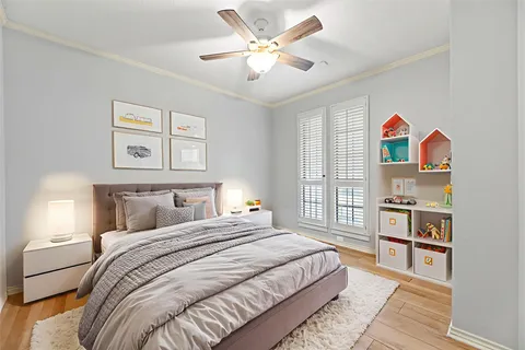 a bedroom with a bed cabinets and window