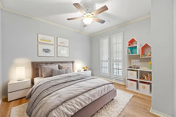 a bedroom with a bed cabinets and window