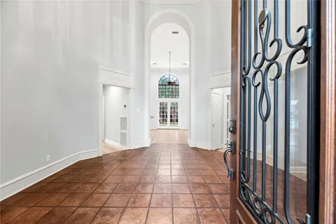 a view of a hallway with entryway wooden floor and front door