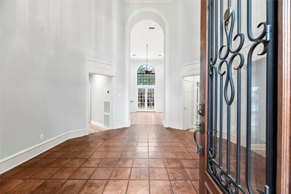 a view of a hallway with entryway wooden floor and front door