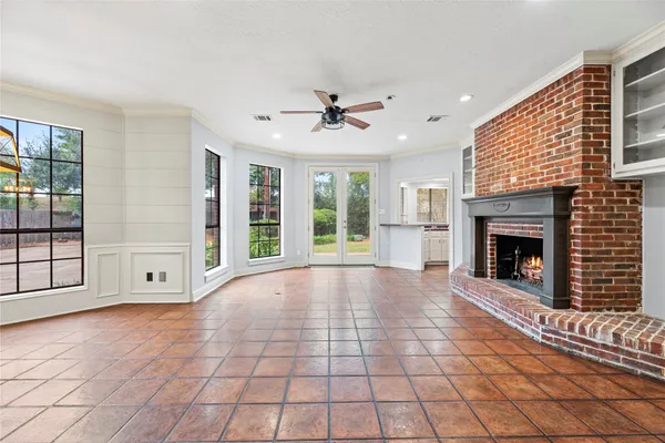 a view of an empty room with a fireplace and a window