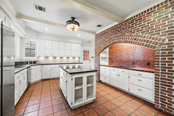 a kitchen with stainless steel appliances granite countertop a stove and cabinets