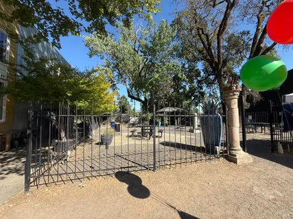 a view of house with backyard and sitting area