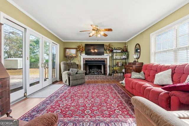 a living room with furniture fireplace and a large window