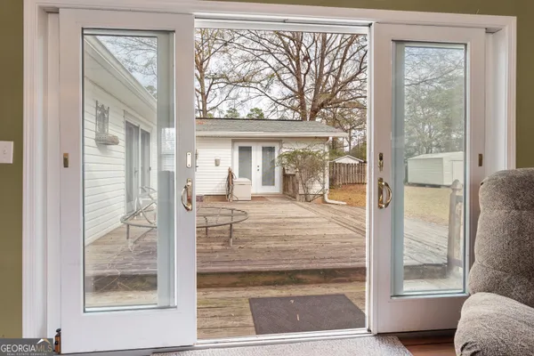 a view of front door with furniture and a window