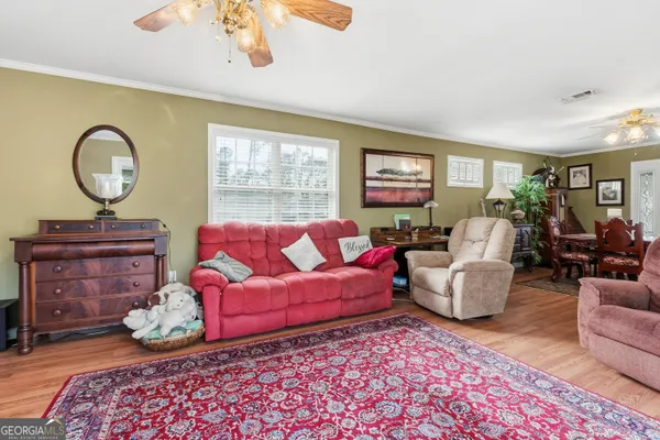 a living room with furniture a fireplace and a window