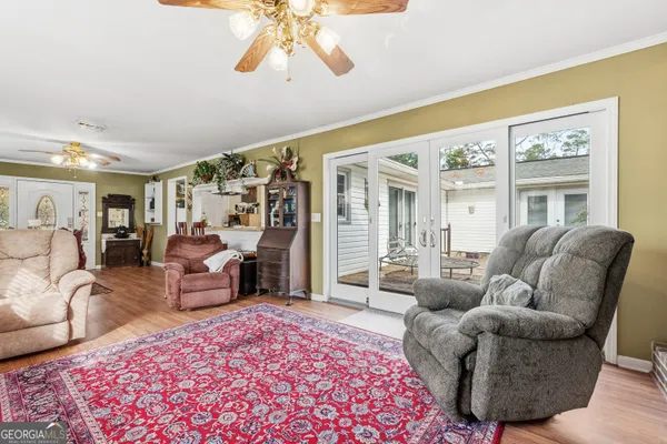 a living room with furniture a rug and a large window