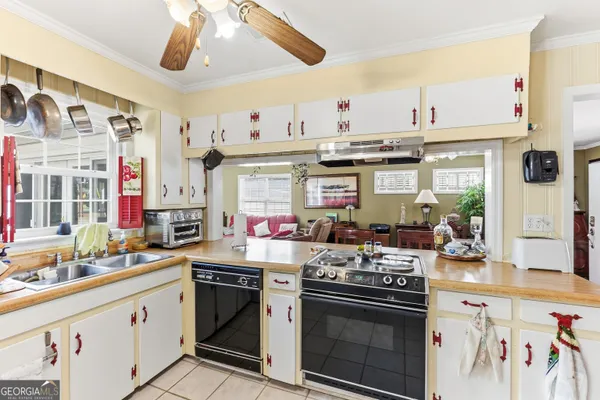 a kitchen with stainless steel appliances granite countertop a stove and cabinets