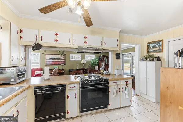 a kitchen with stainless steel appliances granite countertop a stove and a sink