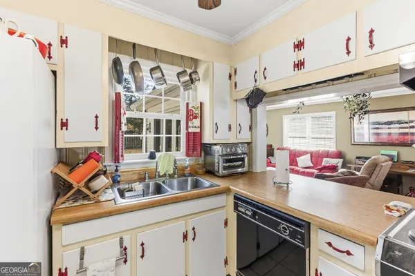 a kitchen with stainless steel appliances a sink and a window