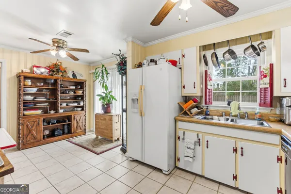 a kitchen with refrigerator and cabinets