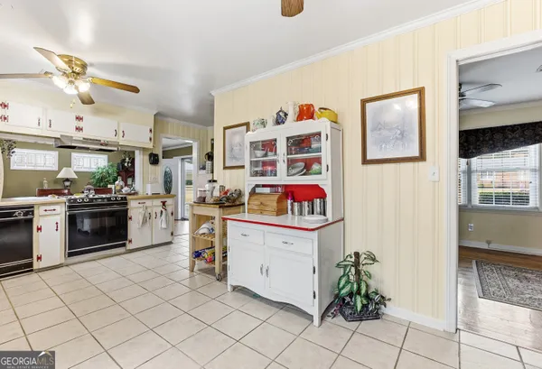 a kitchen with stainless steel appliances a stove a refrigerator and cabinets