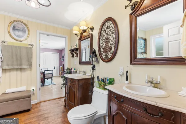 a bathroom with a toilet a sink and a mirror
