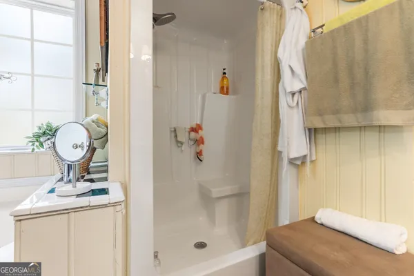 a bathroom with a sink a mirror and shower