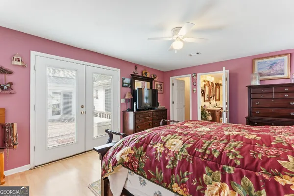 a bed sitting in a bedroom next to a window