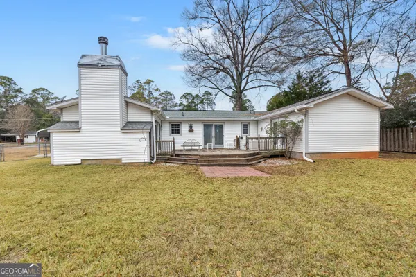 a house view with swimming pool in front of it