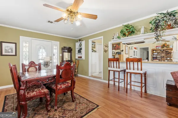 a dining room with furniture wooden floor and a rug