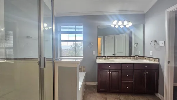 a bathroom with a double vanity sink and a mirror