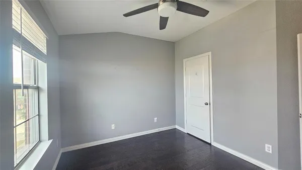 an empty room with windows and entrance