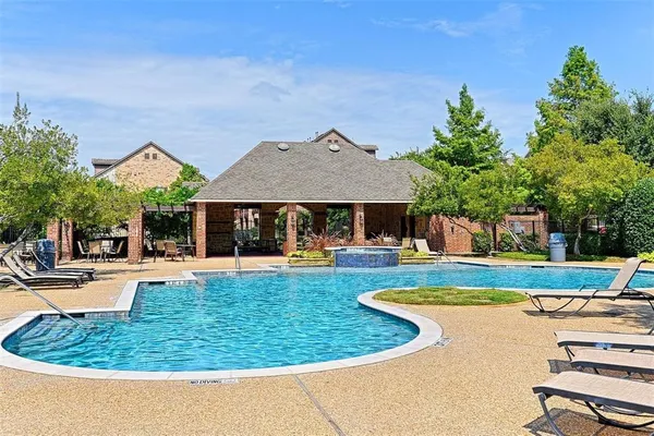 a view of a house with swimming pool and sitting area