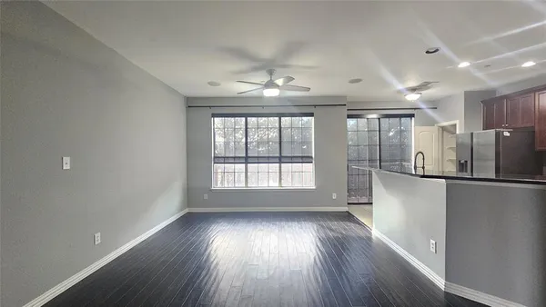 a view of a room with wooden floor and a window