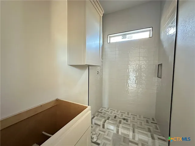 a bathroom with a bathtub and shower