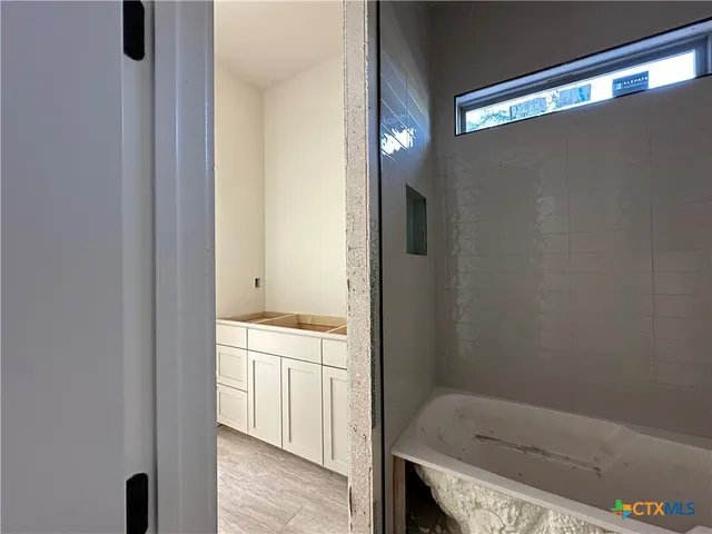 a bathroom with a bathtub and shower