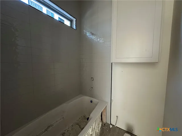 a bathroom with a tub and shower