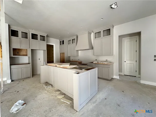a kitchen with a stove and a refrigerator