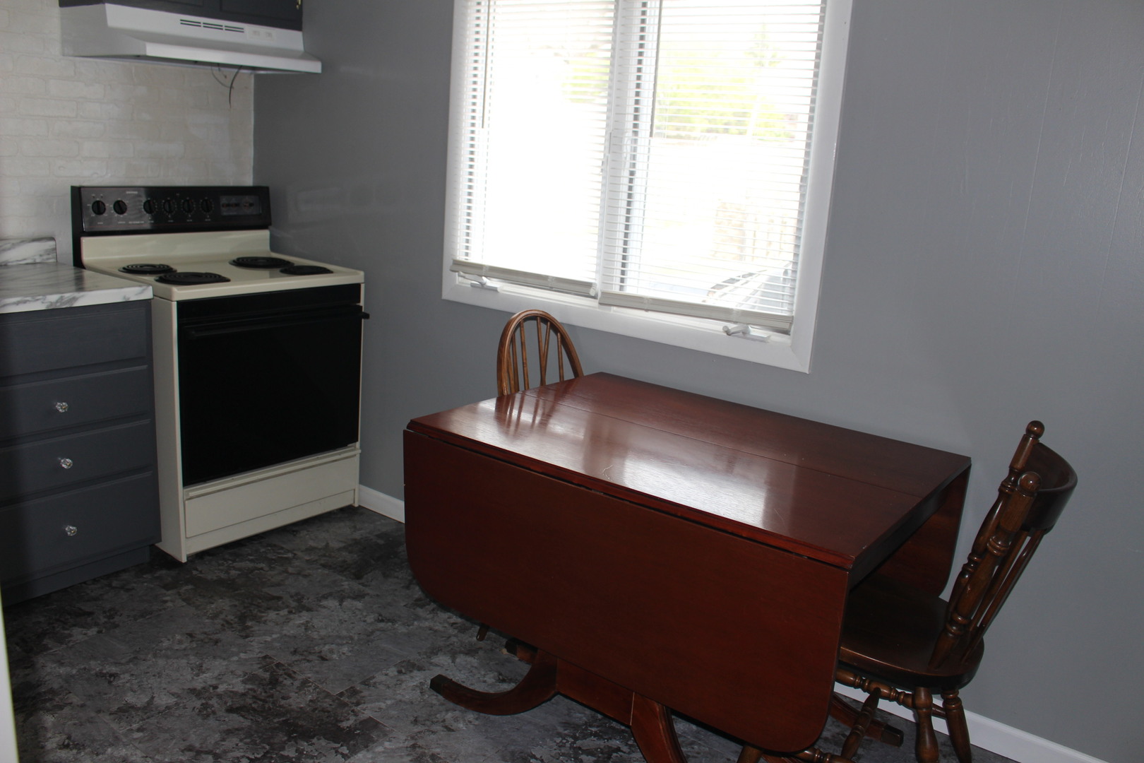 216 South Grant Street Clinton, IL 61727 - Photo 12 of 29 a kitchen with a sink cabinets and window