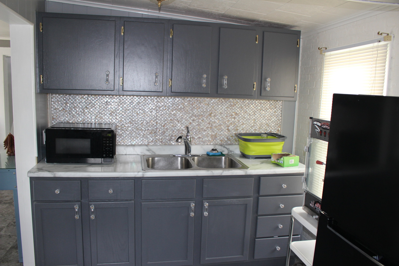 216 South Grant Street Clinton, IL 61727 - Photo 13 of 29 a kitchen with a sink a stove and cabinets