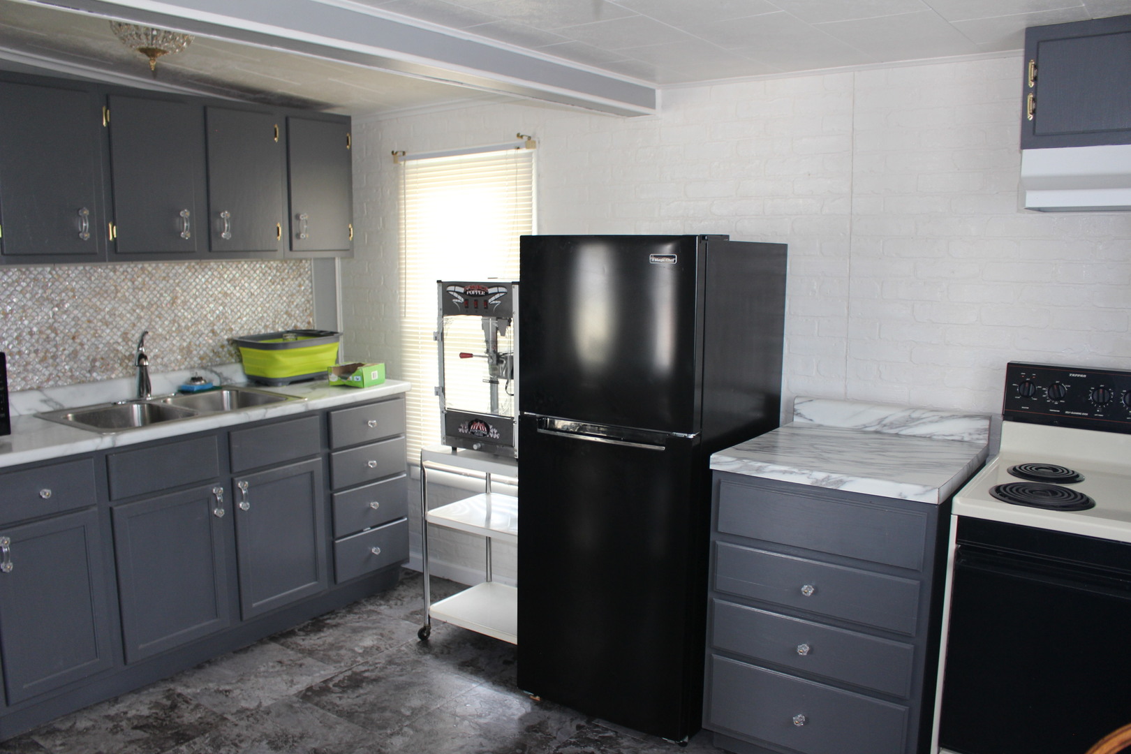216 South Grant Street Clinton, IL 61727 - Photo 14 of 29 a kitchen with stainless steel appliances granite countertop a refrigerator and a stove top oven