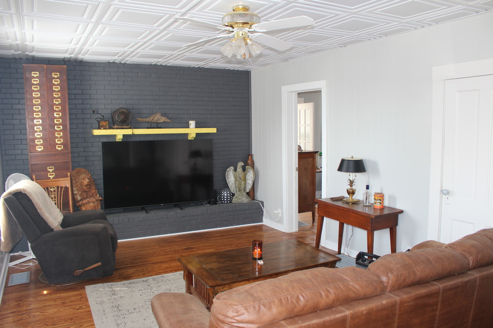 216 South Grant Street Clinton, IL 61727 - Photo 5 of 29 a living room with furniture and a fireplace