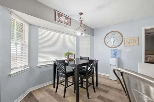 a view of a dining room with furniture and a window