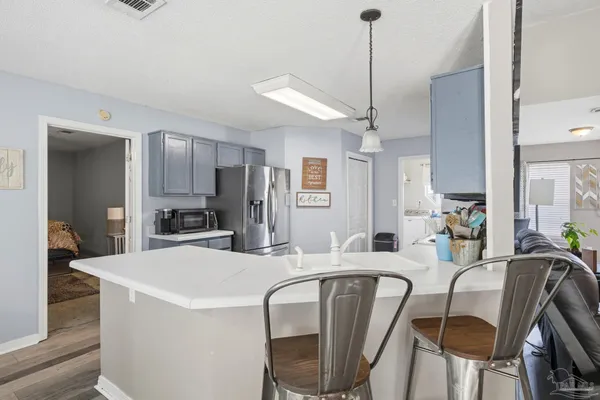 a dining room with furniture and a chandelier
