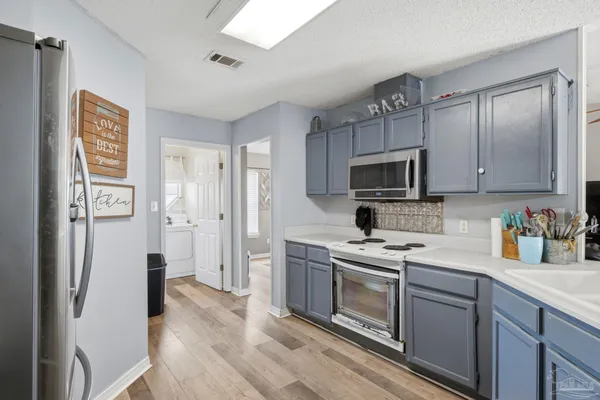 a kitchen with stainless steel appliances granite countertop a refrigerator stove and sink