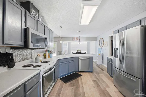 a kitchen with a sink appliances and cabinets