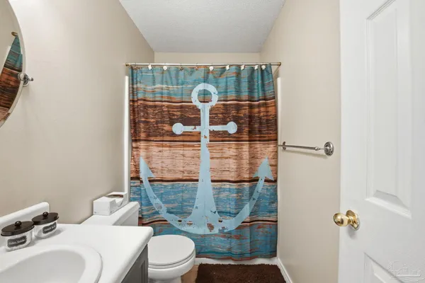 a bathroom with a toilet and shower