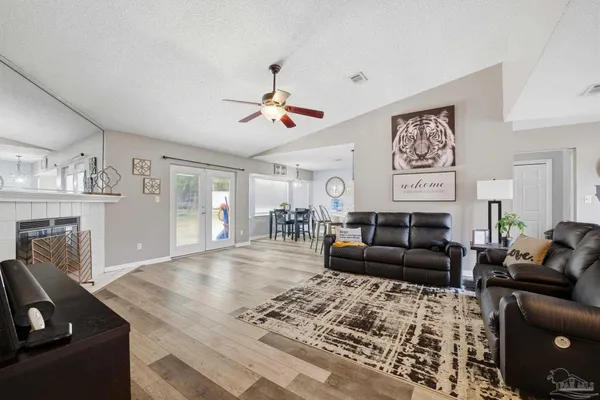 a living room with furniture and a fireplace