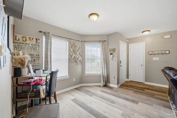 a view of a livingroom with furniture and windows