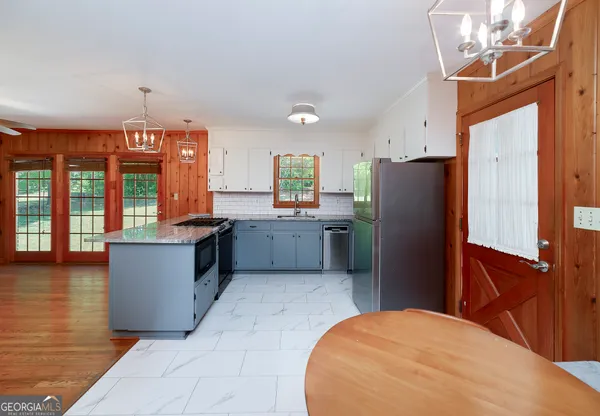a kitchen with refrigerator and window