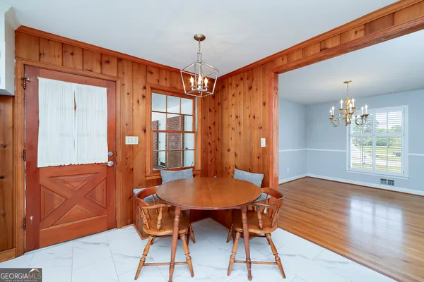 a view of a dining room with furniture window and wooden floor