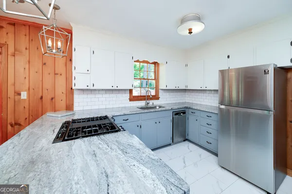 a kitchen with stainless steel appliances a refrigerator sink and stove