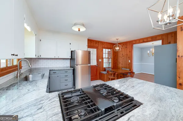 a kitchen with refrigerator and outdoor view