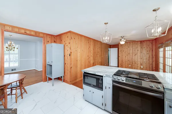 a kitchen that has a stove and a table
