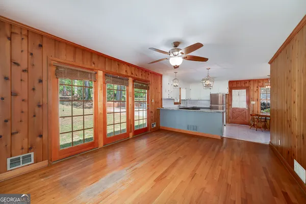 a view of a kitchen with wooden floor and a kitchen